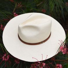 Handwoven from sustainably sourced toquilla straw, known for its durability, breathability, and flexibility, the Alexandria Panama hat is styled with your choice of a tan, chocolate brown, or black leather band. The Alexandria is a great option for anyone building their capsule accessories collection. #fedorahat #strawhat #Panamahat #ethicalhat #sustainablehat Luxury Curved Brim Panama Hat For Beach, Luxury Adjustable Fedora For Beach, Luxury Adjustable Fedora For The Beach, Elegant Brimmed Hat Bands For Ranch, Elegant Brown Hat Band For Everyday, Luxury Flat Brim Fedora For Vacation, Luxury Brimmed Panama Hat For Vacation, Luxury Adjustable Straw Hat Made Of Toquilla Straw, Luxury Wide Brim Adjustable Straw Hat