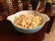 a bowl filled with food sitting on top of a wooden table