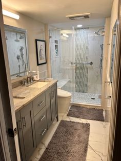 a bathroom with a walk in shower next to a sink