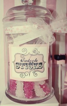 a glass jar filled with pink and white candies