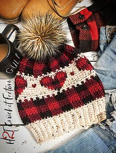 a knitted hat with a pom - pom sitting on top of it