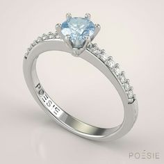 a white gold engagement ring with an aqua blue topazte and diamond sidestones