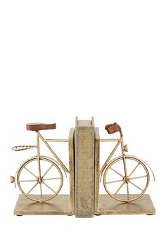 an old fashioned bicycle bookend is sitting on a white background