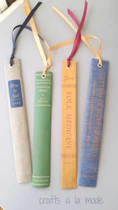 three bookmarks with ribbons on them sitting next to each other