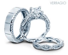 two wedding rings with an intricate design on the side and one diamond in the middle