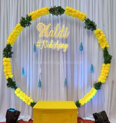 the backdrop is decorated with yellow flowers and greenery