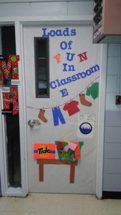 a classroom door decorated with clothes hanging on the line and an open door that says loads of fun in classroom e