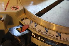 a close up of a metal object with a tape measure on it's side