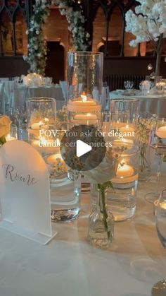 the table is set with candles, flowers and place cards for guests to sit at