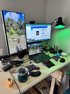 two computer monitors sitting on top of a desk