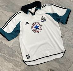 an adidas jersey laying on the floor