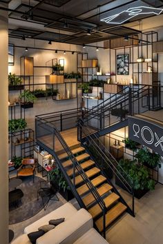 the interior of an office building with stairs and plants