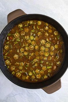 a pot filled with stew sitting on top of a table