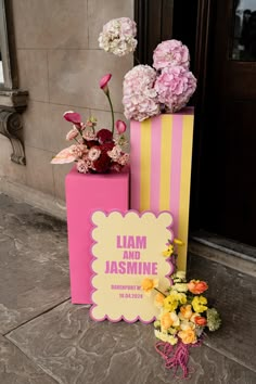 pink and yellow boxes with flowers in them on the ground next to a sign that says jam and jasmine