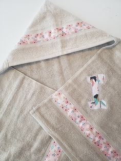 three pieces of cloth laid out on top of each other, one with a patch in the middle