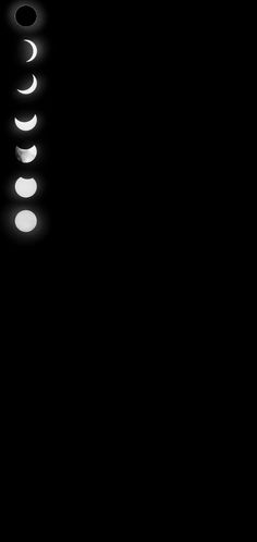 a black and white photo of the moon in the sky with light circles around it