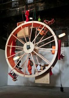 a large wooden wheel hanging from the ceiling