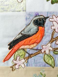 a bird sitting on top of a tree branch next to pink and white flowered branches