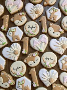 decorated cookies are arranged in the shape of numbers and deers, with names on them