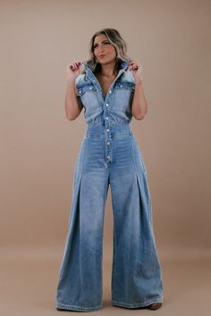 Make a bold style statement with the Doing The Most Denim Button-Up Jumpsuit. This trendy piece combines comfort and fashion in an effortlessly chic design. Dress it down with sneakers for a laid-back look or elevate it with heels for a night out. Denim jumpsuit Functional buttons Collared neckline Snap Buttons﻿ Flared bottoms Long Cut-sleeves Denim Imported 90% cotton, 10% polyester Measurements: (Approximate. Measured laying flat *Snap buttons allow for more room in the bust area!) S Waist 30" Button Up Jumpsuit, Flared Bottoms, Short Satin Dress, Denim Jumpsuits, Flare Jumpsuit, Trendy Denim, Long Cut, Everyday Chic, Bold Style