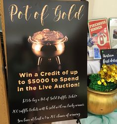 a pot of gold sign sitting on top of a table