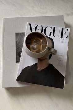 an image of a magazine cover with a man's head in a cup on it