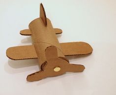 an airplane made out of cardboard sitting on top of a table