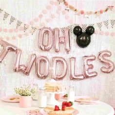 a minnie mouse balloon that says oh moddles on top of a white table