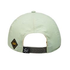 a green hat with black patches on the front and back side, sitting against a white background