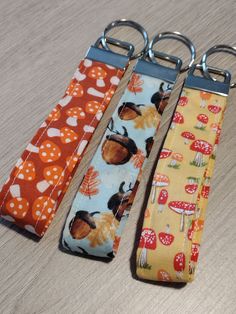 three key chains with different designs on them