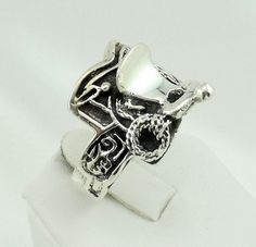 "Vintage sterling silver ring in the shape of a saddle. Stamped \"925\". A great gift for any barrel riding cowgirl! FREE SHIPPING! Details: Sterling Silver: (as shown in picture) Ring Top Dimensions: 3/4 inch x 3/4 inch Ring Size: 12 1/2 Total Weight: 14.9 grams FREE Domestic Shipping by USPS Priority Mail delivery confirmation and includes insurance. If the item is to be shipped internationally Etsy will calculate postage Please notify us at time of purchase if you are buying more than one ite Western Style Stamped 925 Rings As Gift, Western Style 925 Silver Rings As Gifts, Ctr Rings, Picture Ring, Saddle Ring, Jewellers Bench, Vintage Sterling Silver Rings, Mail Delivery, Cow Girl