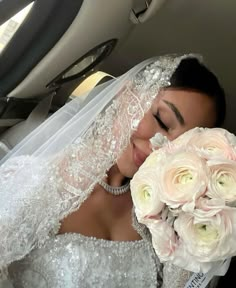 a woman in a wedding dress holding a bouquet of flowers and posing for the camera