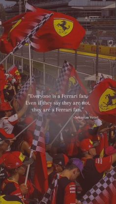 a group of ferrari fans holding flags in front of a race track with the quote everyone is a ferrari fan even if they say are not, they are ferrari fans