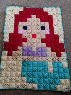 a crocheted square with a little mermaid on it