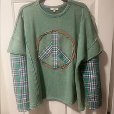 Stylish Green Shirt Featuring A Peace Sign Design. Perfect For Casual Wear. 84% Cotton 16% Poly Contrast 1: 65% Poly 35% Cotton Contrast 2: 84% Cotton 16% Poly 26” Long 27” Pit To Pit Reworked Sweater, 2024 Fits, Sweatshirt Refashion, Cozy Wear, Upcycled Dress, Upcycled Clothes, Green Shirt, Upcycle Clothes, Peace Sign