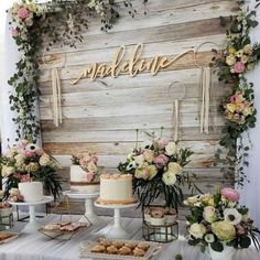 a table topped with lots of cakes and desserts next to a sign that says goodbye