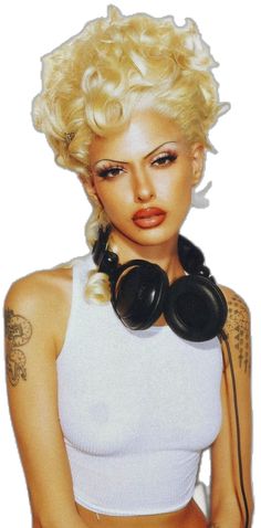 a woman with blonde hair and headphones on her neck is posing for the camera