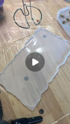 a video demonstrating how to cut vinyl with scissors and glue on the floor in preparation for painting