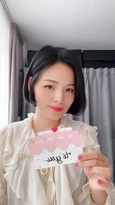 a woman holding up a card that says to you