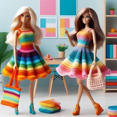 two dolls are dressed in colorful crocheted dresses and purses, one is holding a handbag