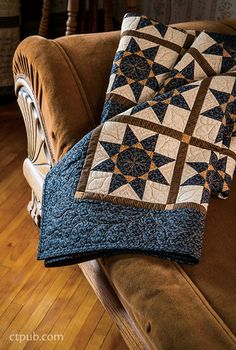 two blue and brown quilts on a couch