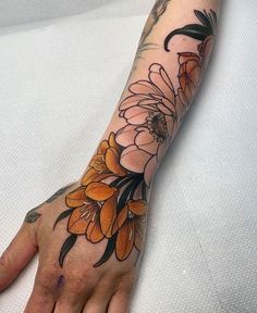 a person's arm with flowers on it