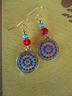 ♥Jewelry designs made by hand with heART♥ These beautiful tie dye design mandala charm earrings feature red Swarovski crystal beads, brass accent beads and seed beads which compliment the mandala charm. Lovely, FUN, Hippie Days lightweight earrings. These earrings measure 2 inches from the top of the ear wires. Handmade and ready to ship. Ready to give away or to treat yourself! Enjoy ♥ Thank you for visiting ♥third time charms♥ Multicolor Single Earring As Gift, Multicolor Single Earring Jewelry Gift, Bohemian Multicolor Hypoallergenic Earrings, Bohemian Multicolor Hypoallergenic Jewelry, Multicolor Pierced Dangle Jewelry, Multicolor Crystal Earrings Gift, Round Metal Beaded Earrings As Gift, Multicolor Adjustable Crystal Earrings For Pierced Ears, Multicolor Nickel-free Dangle Earrings