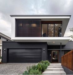 a modern house with black siding and white trim