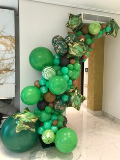 a balloon column with green and brown balloons