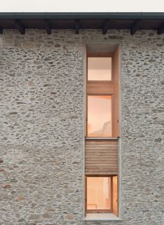 a window on the side of a stone building