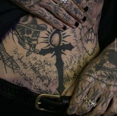 a person with tattoos on their body and hands