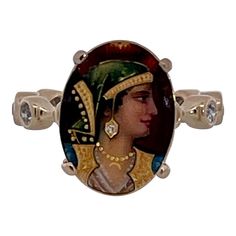 This is part of Chairish’s Fine Jewelry assortment.  Enamel Faced Portrait of Athena Ring 14K  This ring has a beautiful face of Athena a Roman goddess.  This started life as a Stick pin but I couldn't help myself I had to turn this into a ring.  The face is beautiful with a tiny Diamond on her ear.  The band is set with ten 0.10 point Diamonds circling the band. Colors are beautiful it weighs in at 6.09 grams and is a size 5 3/4. This ring is perfect for those with smaller fingers or it can be Artistic Style Rings, Oval Diamond Ring For Collectors, Oval Diamond Ring For Collectible, Unique Collectible Diamond Rings, Roman Goddess, Three Rings, Circle Diamond, Tiny Diamond, Tie Pin