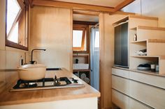 a kitchen area with a stove, sink and cabinets