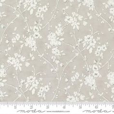 a gray and white flowered wallpaper with small flowers on the left hand side